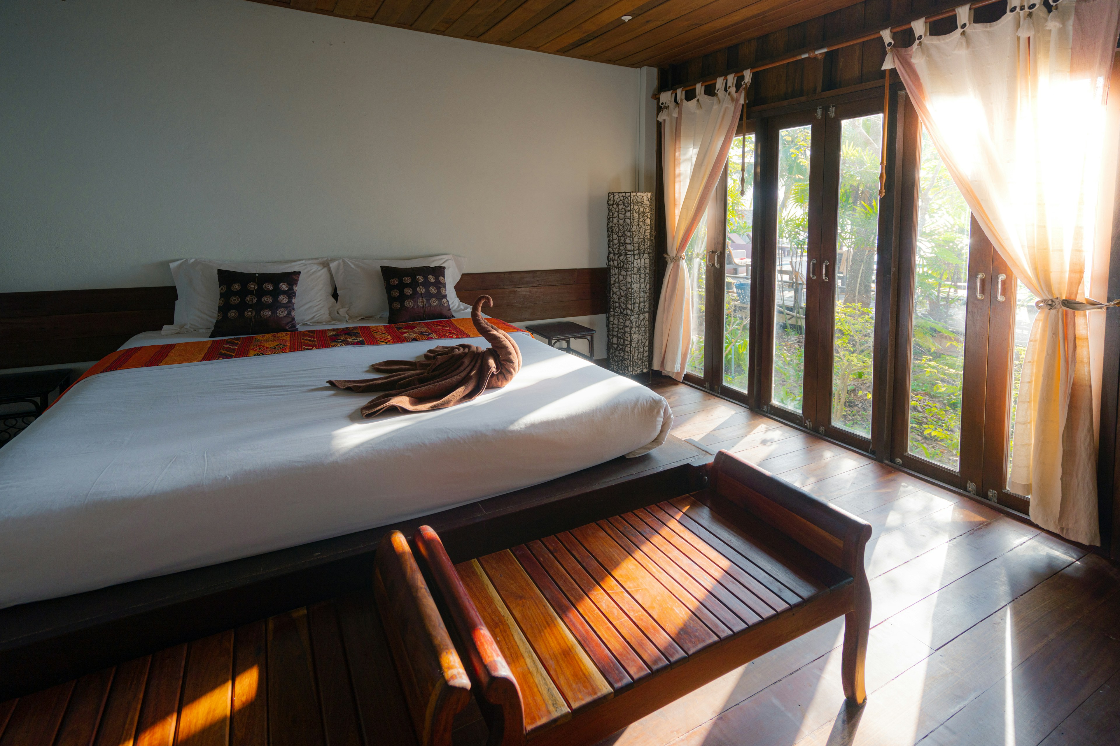 4K Open-air forest verandah with woven hammock overlooking lush tropical greenery